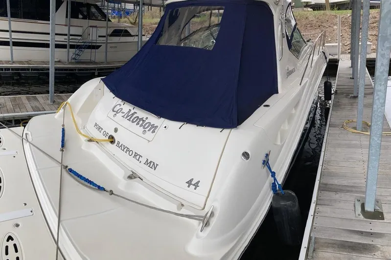 Co-motion Yacht Photos Pics 2008 Sea Ray 44 Sundancer docked, featuring blue canopy and "Co-Motion" nameplate.