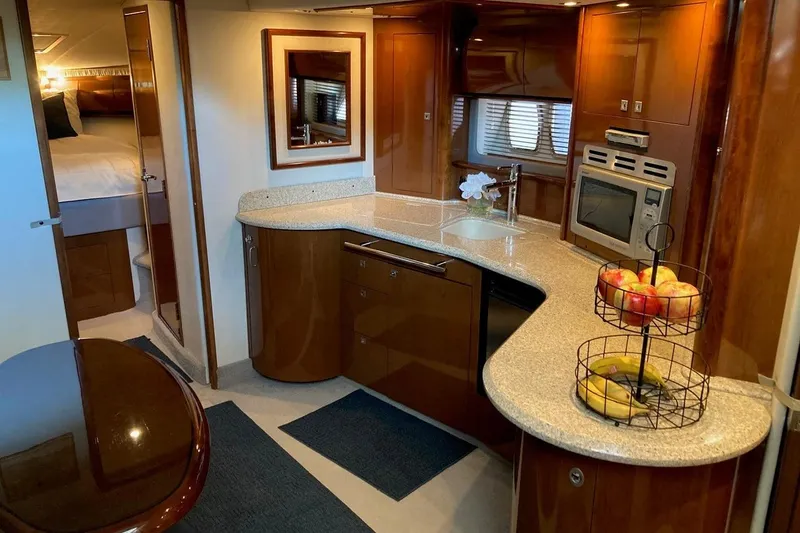 Co-motion Yacht Photos Pics Luxurious 2008 Sea Ray 44 Sundancer yacht interior with modern kitchen and cozy bedroom.