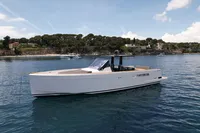 2020 Fjord 40 Open yacht on calm water near a scenic coastline.