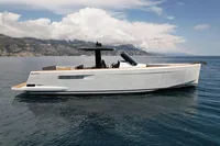 2020 Fjord 40 Open yacht on calm sea with mountainous backdrop.