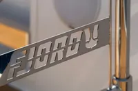 Close-up of 2020 Fjord 40 Open yacht's metallic logo detail.