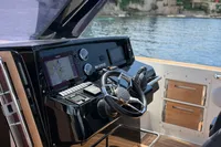 Helm of 2020 Fjord 40 Open yacht with modern controls and scenic water view.