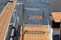Fjord 40 Open 2020 yacht deck with wooden flooring and metal railing.