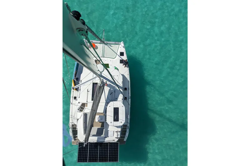 Momentum 42 Yacht Photos Pics Aerial view of 2023 Leopard 42 catamaran on clear turquoise water.