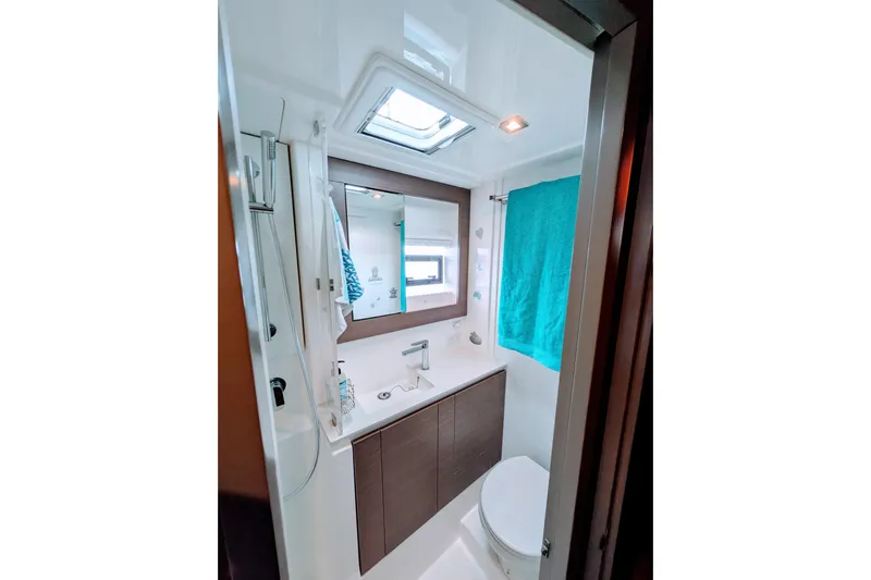 Momentum 42 Yacht Photos Pics Modern bathroom in 2023 Leopard 42 yacht with shower, sink, and teal towel.