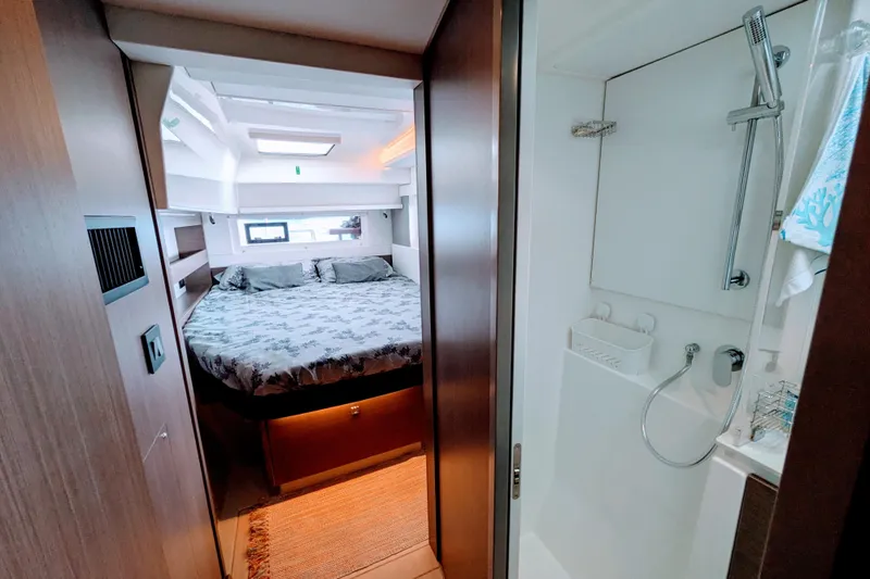 Momentum 42 Yacht Photos Pics Luxurious interior of 2023 Leopard 42 yacht featuring cozy bedroom and modern bathroom.