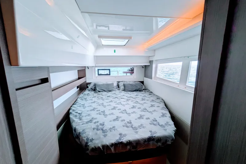 Momentum 42 Yacht Photos Pics Luxurious bedroom interior of 2023 Leopard 42 yacht with ocean view windows.