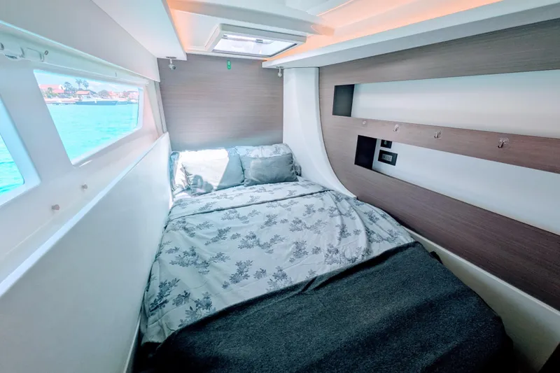 Momentum 42 Yacht Photos Pics Cozy cabin interior of 2023 Leopard 42 yacht with bed and ocean view.