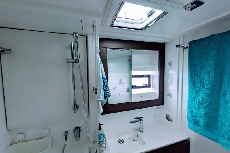 Momentum 42 Yacht Photos Pics Modern bathroom in 2023 Leopard 42 yacht with shower, sink, and teal towel.