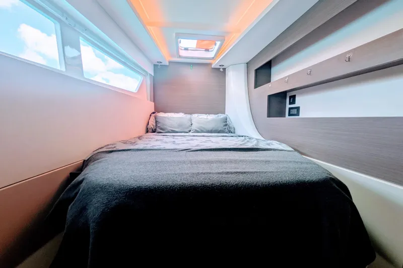 Momentum 42 Yacht Photos Pics Luxurious cabin interior of 2023 Leopard 42 yacht with cozy bed and modern design.