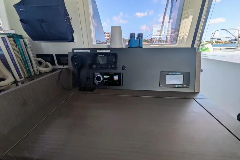 Momentum 42 Yacht Photos Pics 2023 Leopard 42 yacht navigation station with communication equipment and books.