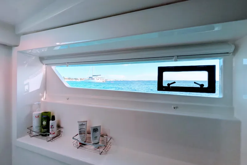 Momentum 42 Yacht Photos Pics Interior view of 2023 Leopard 42 yacht bathroom with ocean view through window.