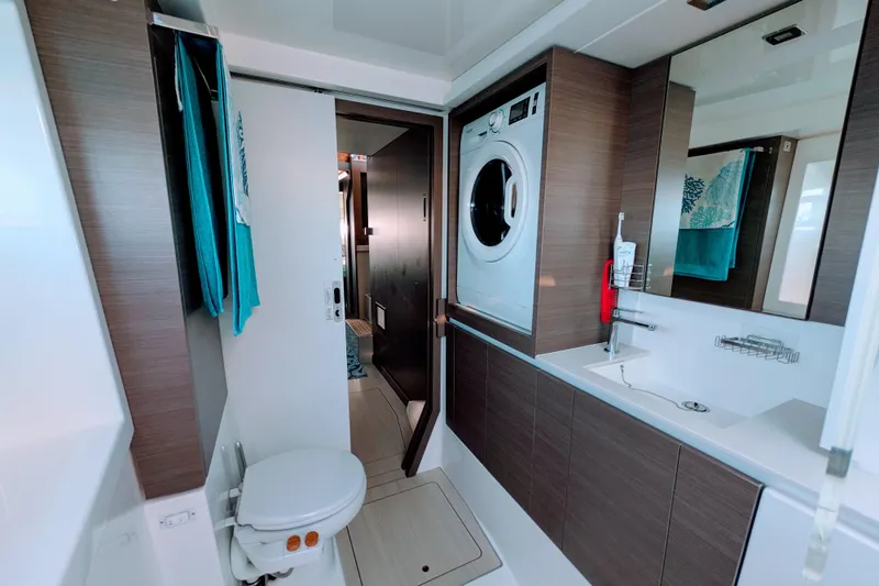 Momentum 42 Yacht Photos Pics Modern bathroom in 2023 Leopard 42 yacht with washer, sink, and toilet.