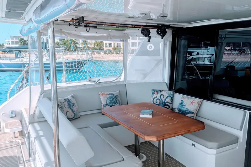 Momentum 42 Yacht Photos Pics Luxurious 2023 Leopard 42 yacht interior with elegant seating and wooden table.