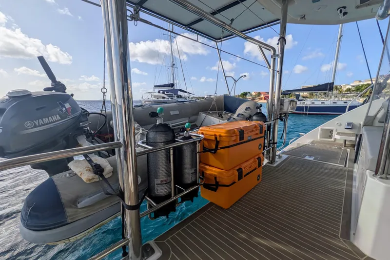 Momentum 42 Yacht Photos Pics Leopard 42 catamaran deck with Yamaha motor, scuba tanks, and orange storage cases, 2023 model.