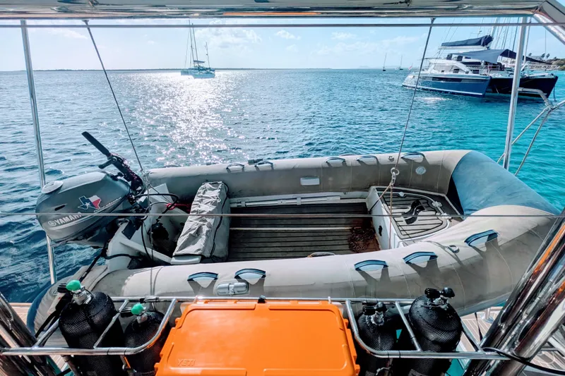 Momentum 42 Yacht Photos Pics Leopard 42 yacht with inflatable dinghy and Yamaha motor on clear blue water, 2023 model.