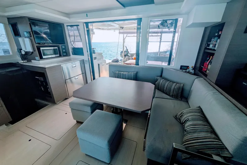 Momentum 42 Yacht Photos Pics Luxurious interior of 2023 Leopard 42 yacht with modern kitchen and cozy seating area.
