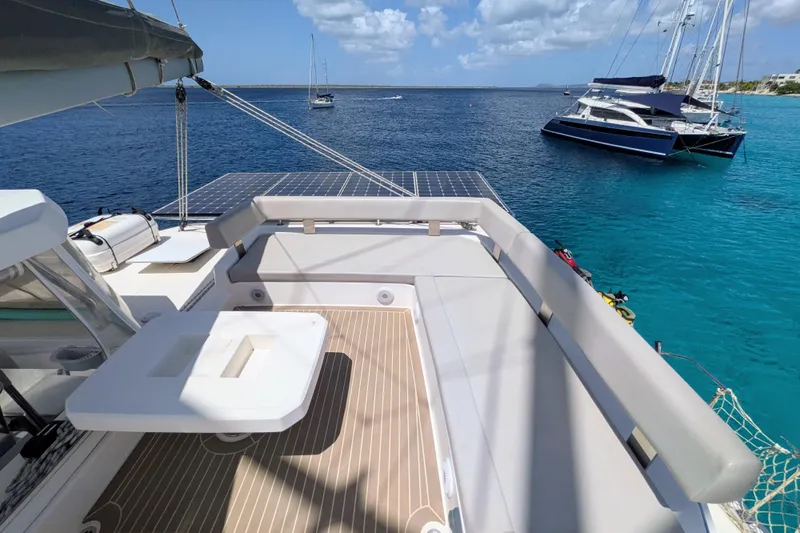 Momentum 42 Yacht Photos Pics Luxurious Leopard 42 catamaran deck with seating, solar panels, and ocean view, 2023 model.