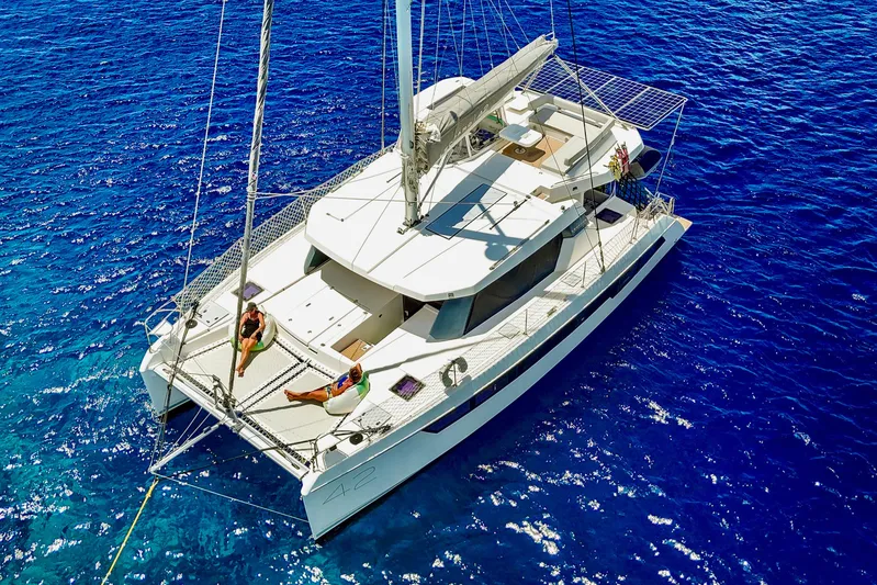 Momentum 42 Yacht Photos Pics 2023 Leopard 42 catamaran sailing on vibrant blue ocean waters.