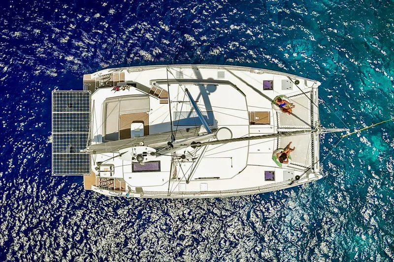Momentum 42 Yacht Photos Pics Aerial view of 2023 Leopard 42 catamaran sailing on vibrant blue ocean waters.