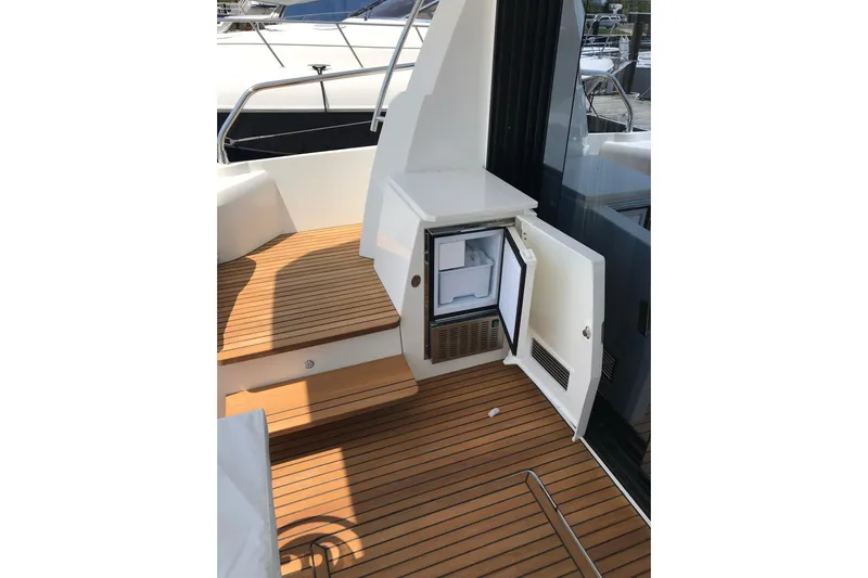 Improbable Yacht Photos Pics 2019 Prestige 520 yacht with open mini fridge on teak deck.