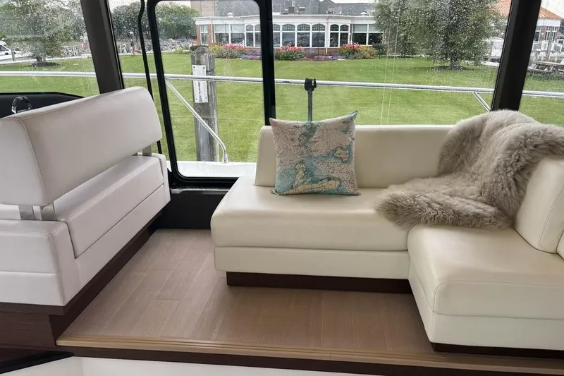 Improbable Yacht Photos Pics Luxurious interior of 2019 Prestige 520 yacht with plush seating and scenic view.