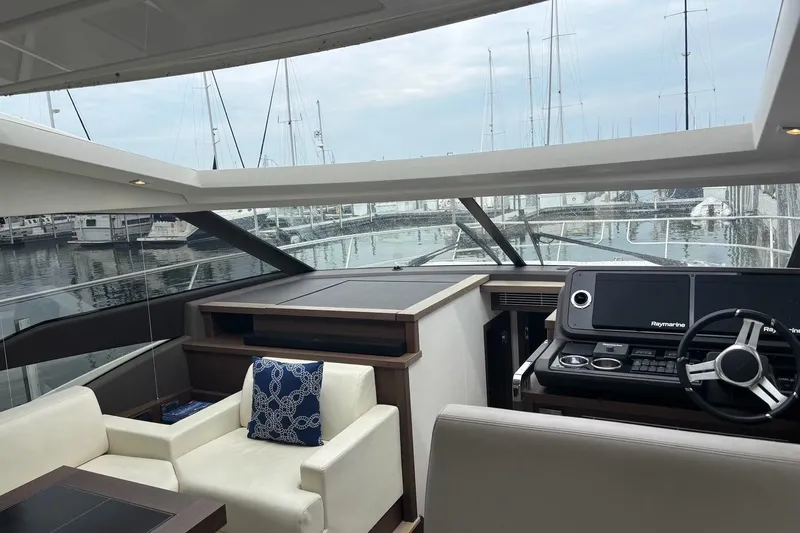 Improbable Yacht Photos Pics Interior view of 2019 Prestige 520 yacht with helm and seating area.