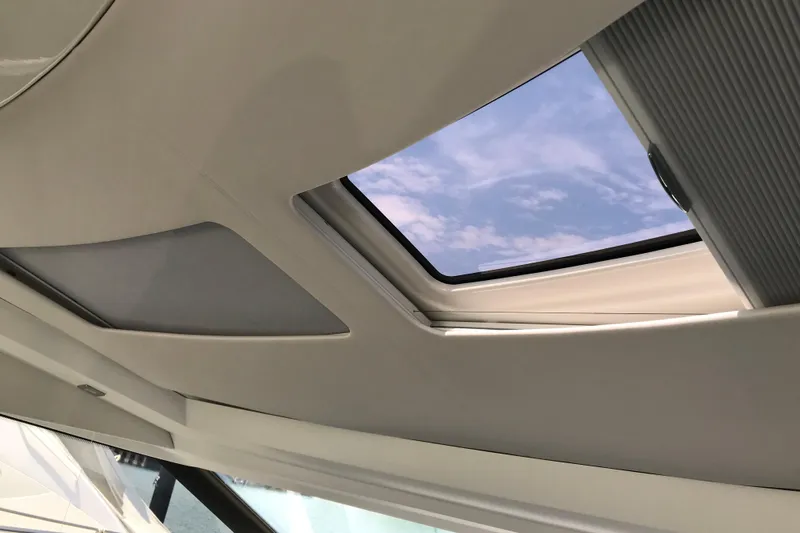 Improbable Yacht Photos Pics Sunroof view from 2019 Prestige 520 yacht, showcasing clear blue sky.
