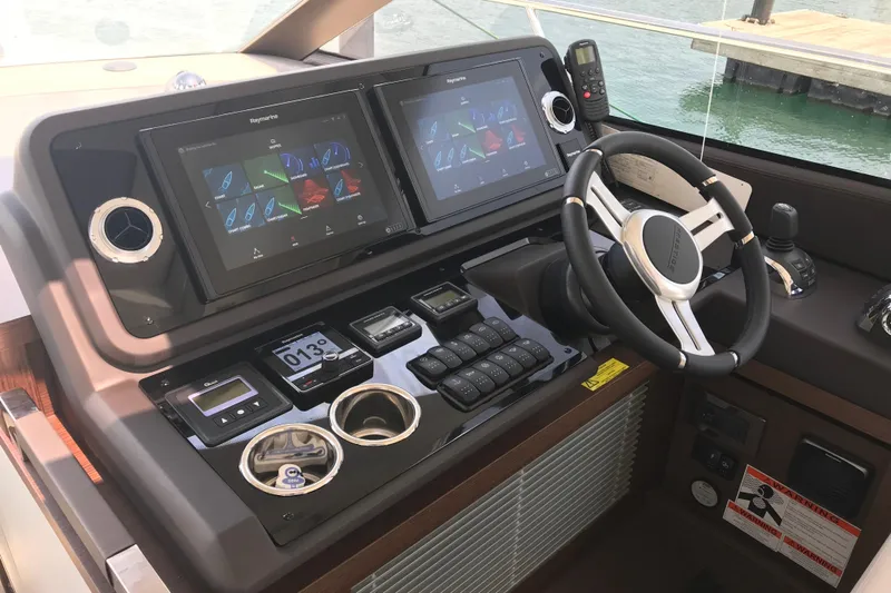 Improbable Yacht Photos Pics Helm of 2019 Prestige 520 yacht with dual Raymarine displays and modern controls.