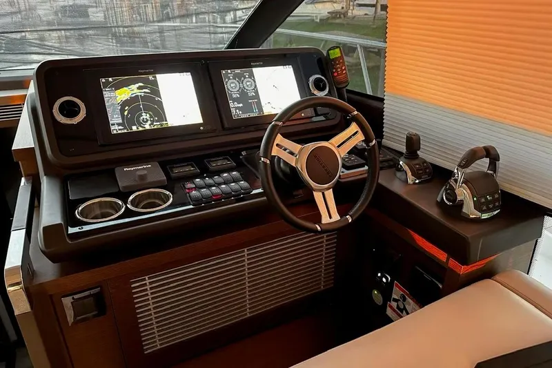 Improbable Yacht Photos Pics Cockpit of 2019 Prestige 520 yacht with advanced navigation controls and steering wheel.