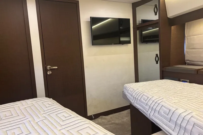 Improbable Yacht Photos Pics Interior of 2019 Prestige 520 yacht cabin with twin beds and wall-mounted TV.