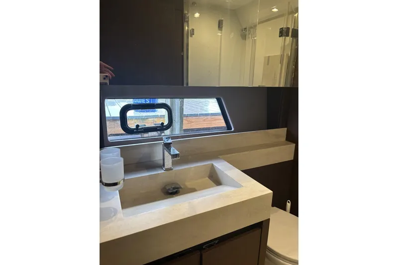 Improbable Yacht Photos Pics Luxurious bathroom in 2019 Prestige 520 yacht with modern sink and window view.