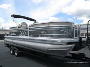 2023 Sun Tracker Party Barge 22 XP3 pontoon boat on trailer under cloudy sky.