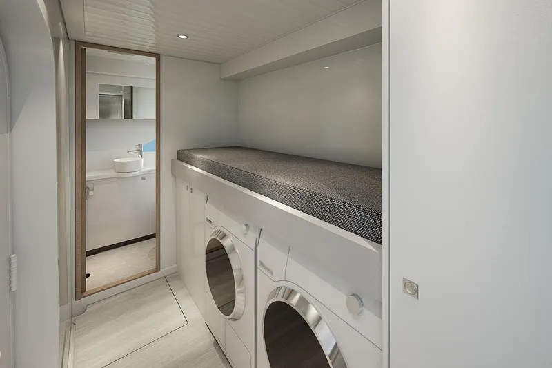  Yacht Photos Pics Manufacturer Provided Image: Laundry area in 2025 Riviera 585 SUV yacht with washer, dryer, and storage.