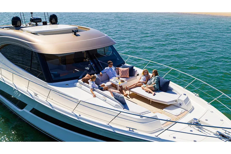  Yacht Photos Pics Manufacturer Provided Image: 2025 Riviera 585 SUV yacht with people relaxing on deck, cruising on open water.