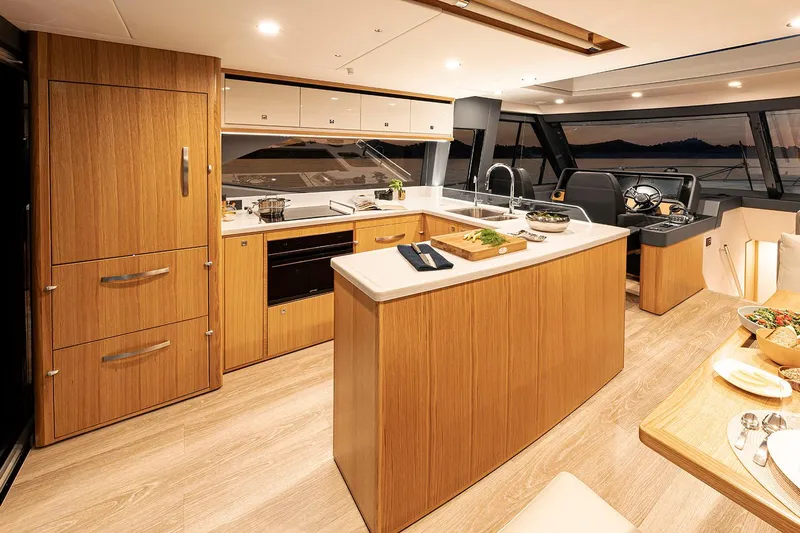  Yacht Photos Pics Manufacturer Provided Image: Luxurious interior of 2025 Riviera 585 SUV yacht with modern kitchen and dining area.