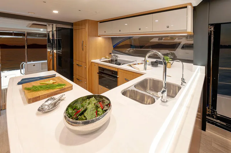  Yacht Photos Pics Manufacturer Provided Image: Luxurious kitchen interior of 2025 Riviera 585 SUV yacht with modern amenities.