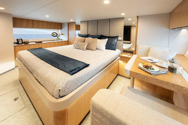  Yacht Photos Pics Manufacturer Provided Image: Luxurious bedroom interior of 2025 Riviera 585 SUV yacht with modern design and ocean view.