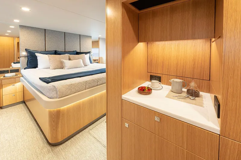  Yacht Photos Pics Manufacturer Provided Image: Luxurious interior of 2025 Riviera 585 SUV yacht with elegant bedroom and kitchenette.