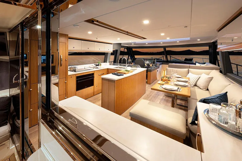  Yacht Photos Pics Manufacturer Provided Image: Luxurious interior of 2025 Riviera 585 SUV yacht with modern kitchen and dining area.