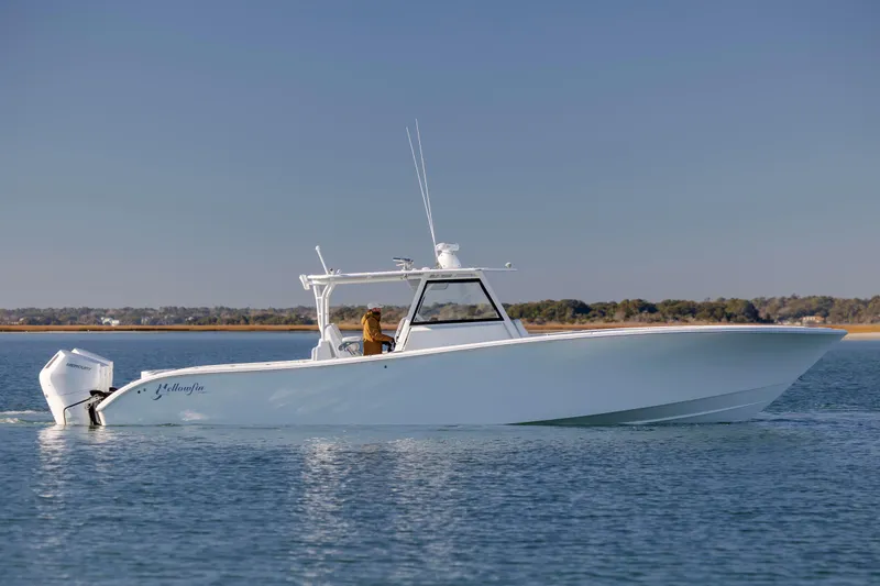  Yacht Photos Pics 2017 Yellowfin 42 Offshore boat cruising on calm water under clear blue sky.