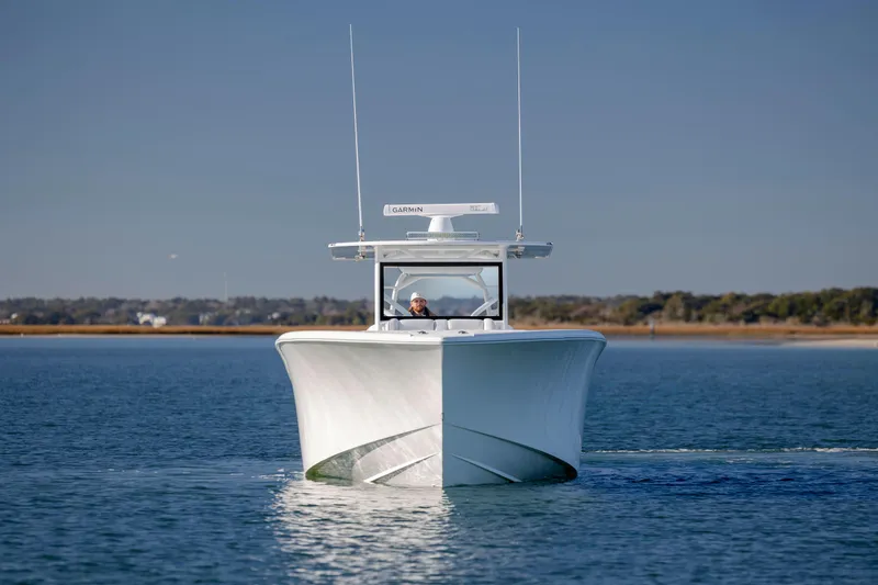  Yacht Photos Pics 2017 Yellowfin 42 Offshore boat cruising on calm water, clear sky background.