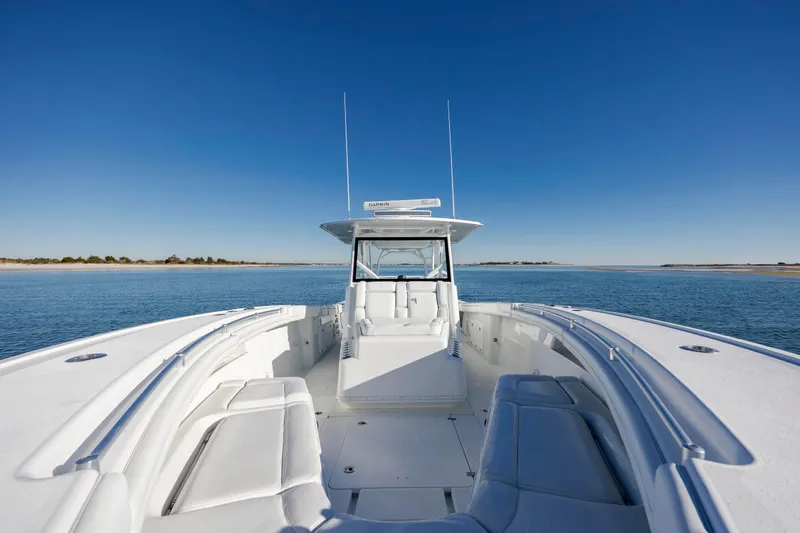  Yacht Photos Pics 2017 Yellowfin 42 Offshore boat on calm water under clear blue sky.