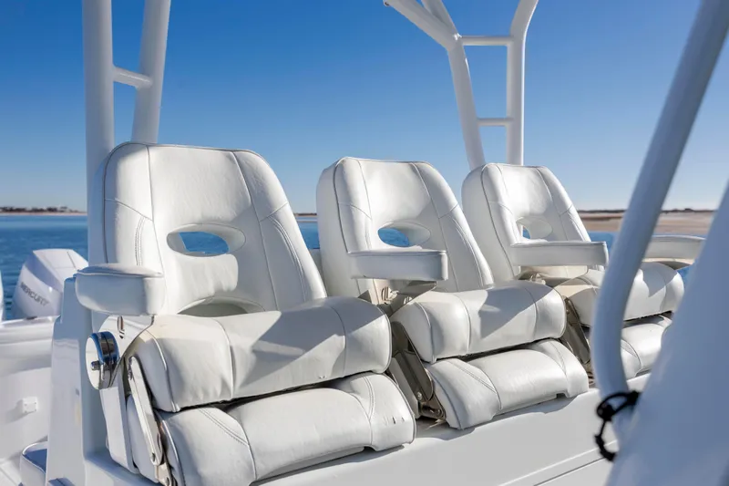  Yacht Photos Pics White leather seats on a 2017 Yellowfin 42 Offshore boat under clear blue sky.
