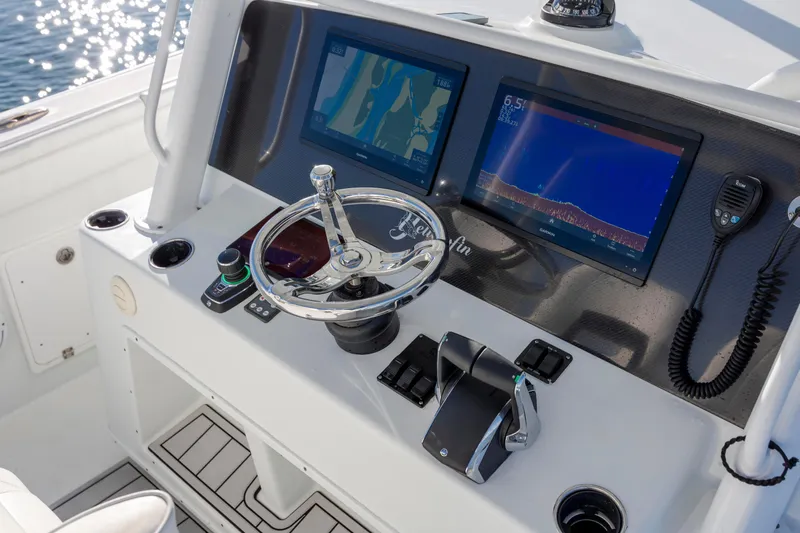  Yacht Photos Pics Control panel of 2017 Yellowfin 42 Offshore boat with navigation screens and steering wheel.