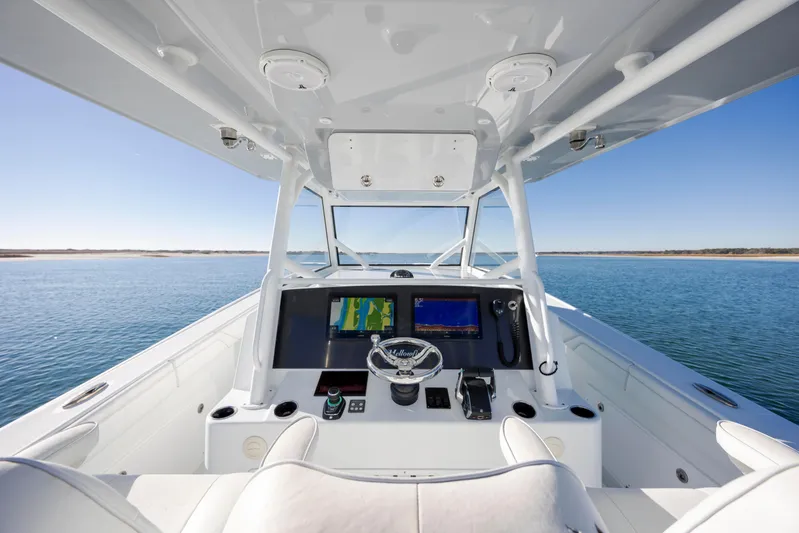  Yacht Photos Pics 2017 Yellowfin 42 Offshore boat helm with navigation screens on open water.