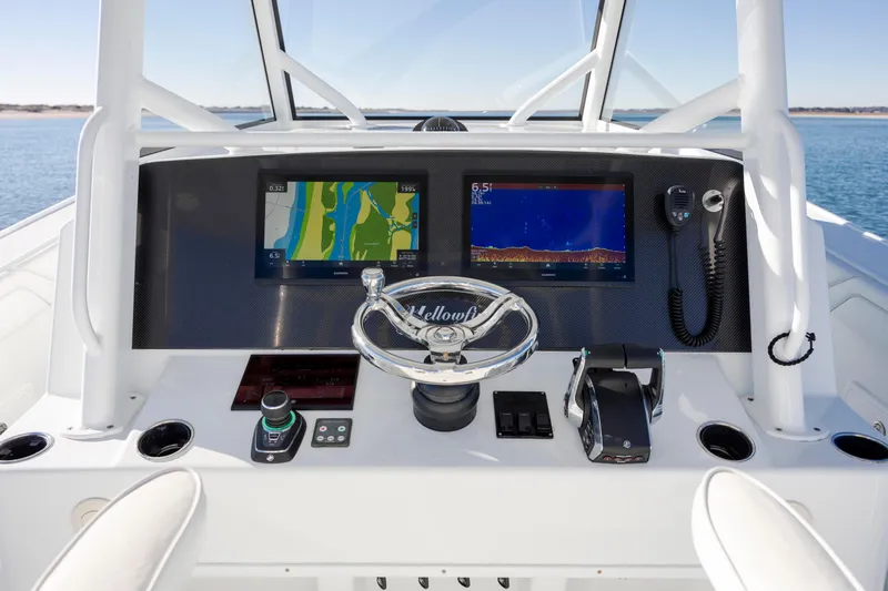 Yacht Photos Pics 2017 Yellowfin 42 Offshore boat dashboard with navigation screens and steering wheel.