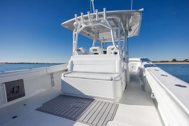  Yacht Photos Pics 2017 Yellowfin 42 Offshore boat interior with seating, under clear blue sky.