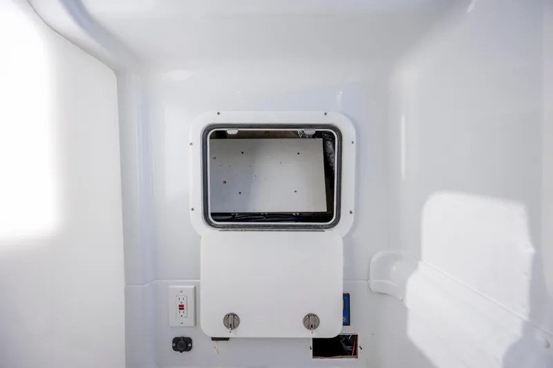  Yacht Photos Pics 2017 Yellowfin 42 Offshore boat interior compartment with white panel and controls.