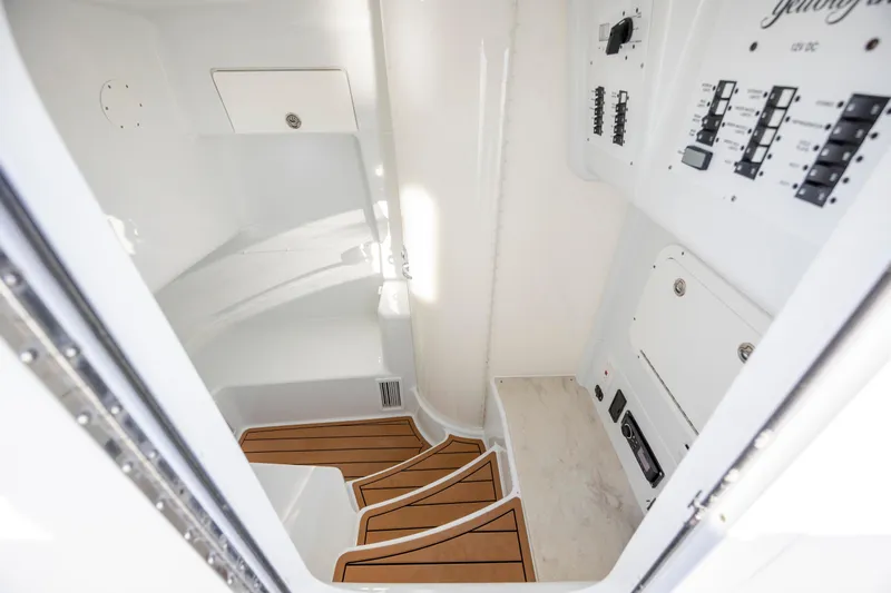  Yacht Photos Pics 2017 Yellowfin 42 Offshore cabin interior with control panels and wooden steps.